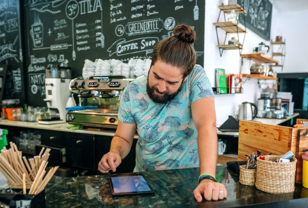 Coffee shop owner reviewing business accounts